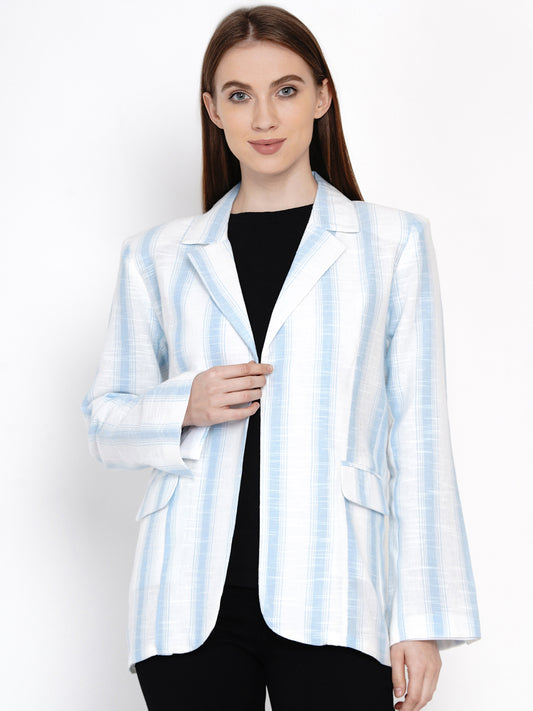 A woman wearing a white and blue striped blazer with a collar, buttoned up, and a black top underneath.