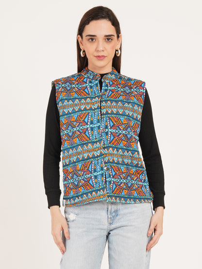 Woman wearing a colorful patterned vest over a black shirt on a white background