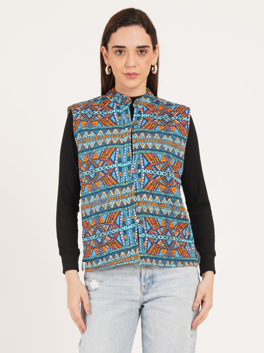 Woman wearing a colorful patterned vest over a black shirt on a white background