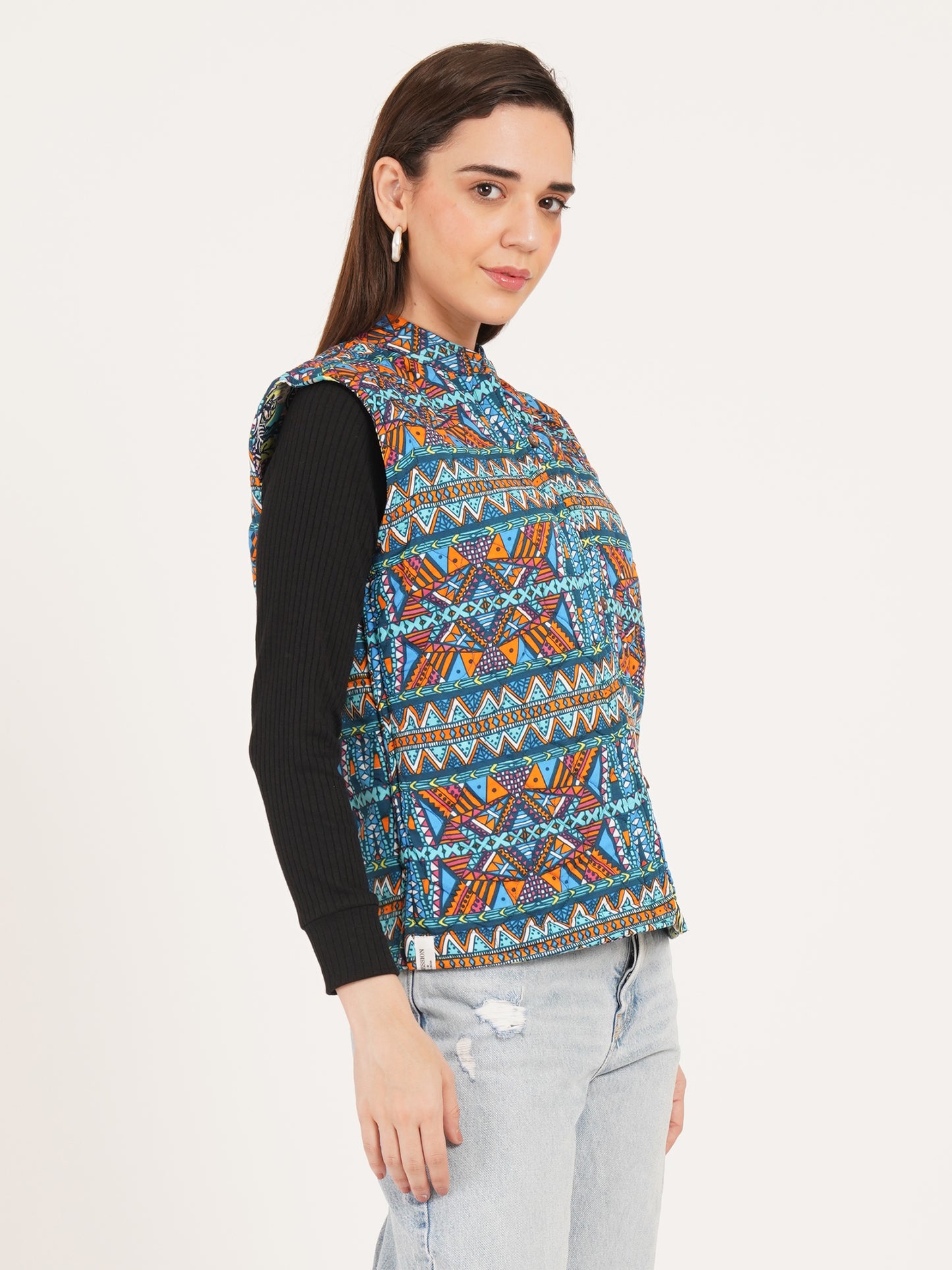 Woman jackets wearing a colorful patterned vest over a black shirt on a white background