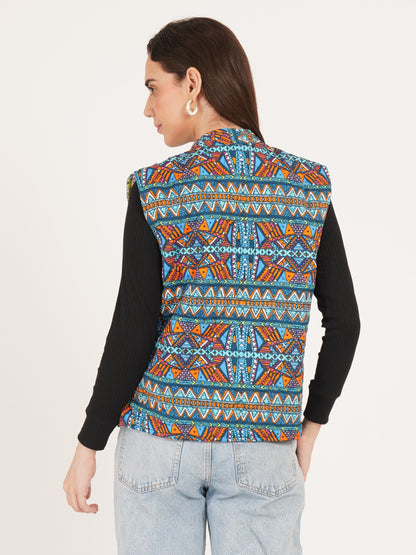 Person wearing reversible jackets a colorful patterned vest on a plain background