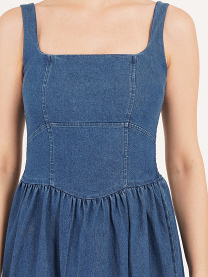 Women dress close look of style develop with fine stitch in blue denim colors gathered at waist.