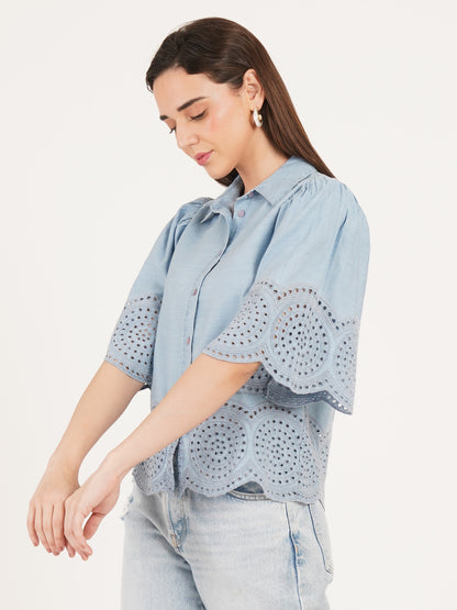 Woman wearing a light blue denim shirt with embroidery by 9 Impression 